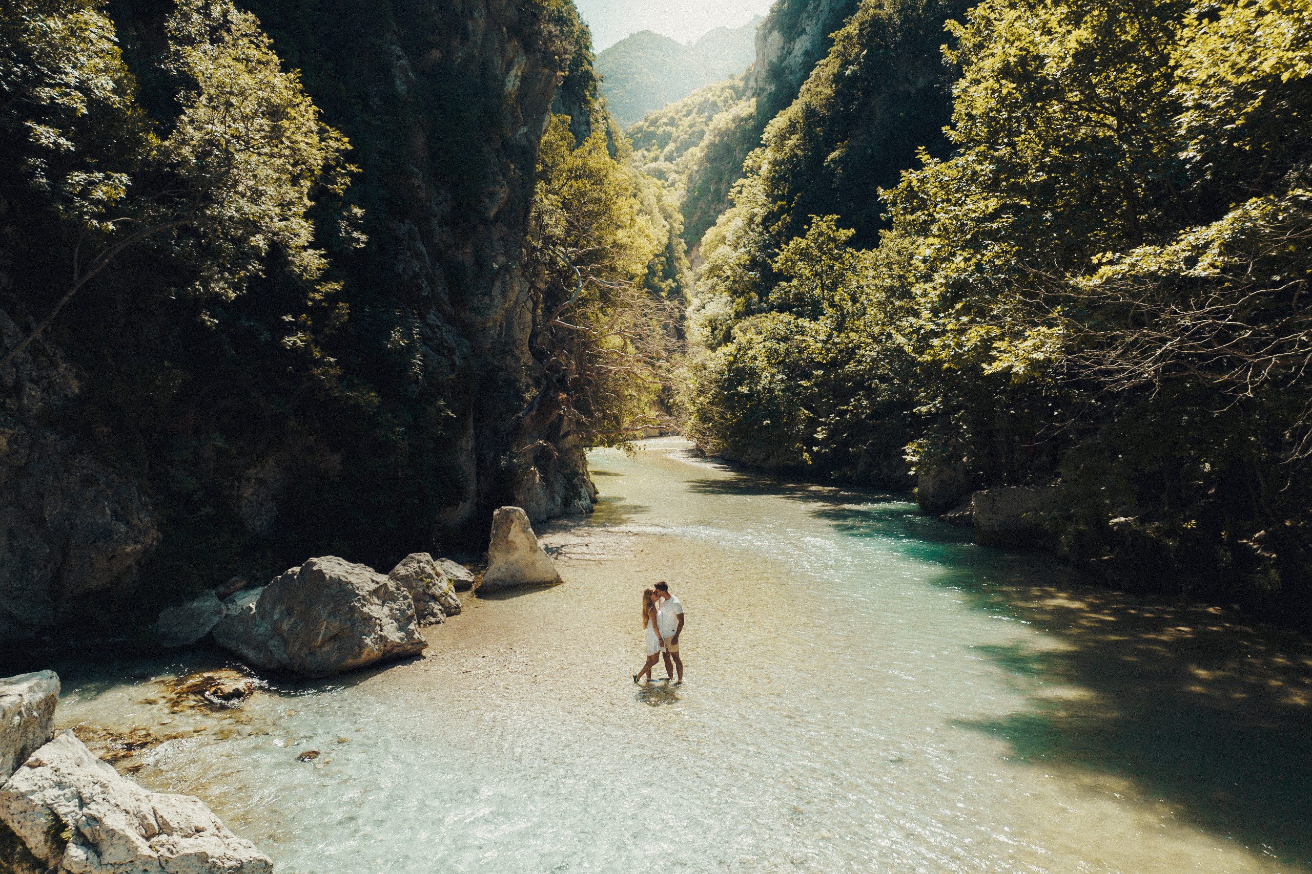 Sivota Greece Things to do. This photo showcase a couple standing in the middle of the Acheron River which is located near to Sivota. This of one of the top things to do when in Sivota and for that reason this photo is the hero of this article.